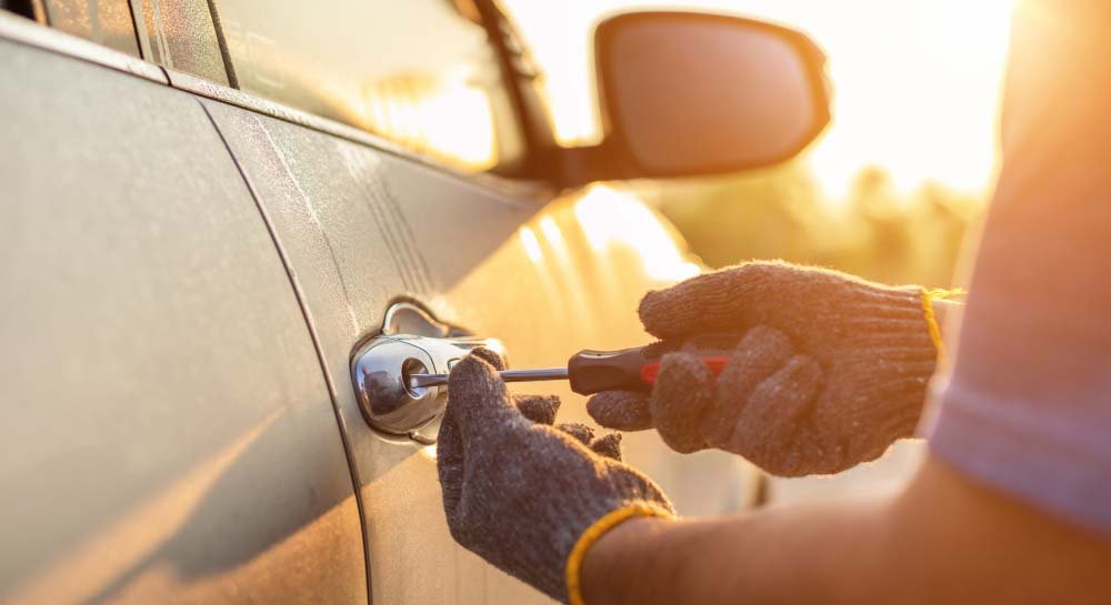 Fine Key Locksmith_Car Technician Wearing White Gloves Using Screwdriver